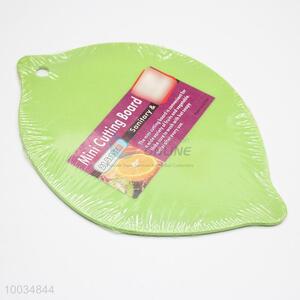 Plastic lemon shaped green cutting board